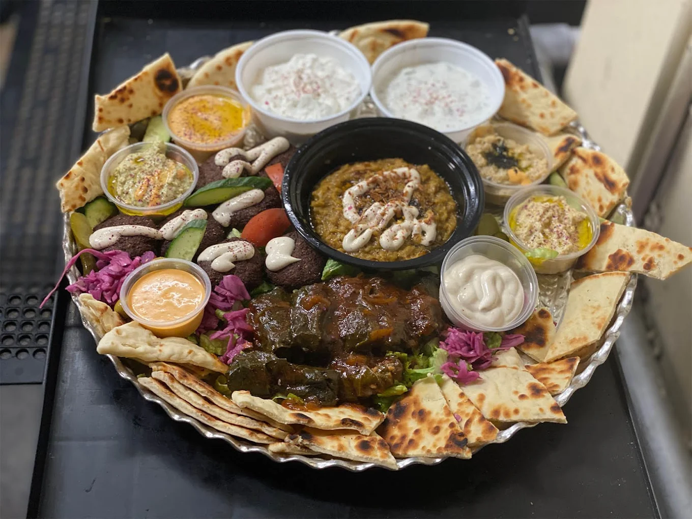 Chef preparing fresh, halal-certified Mediterranean cuisine at Caspian Cuisine on El Camino Real